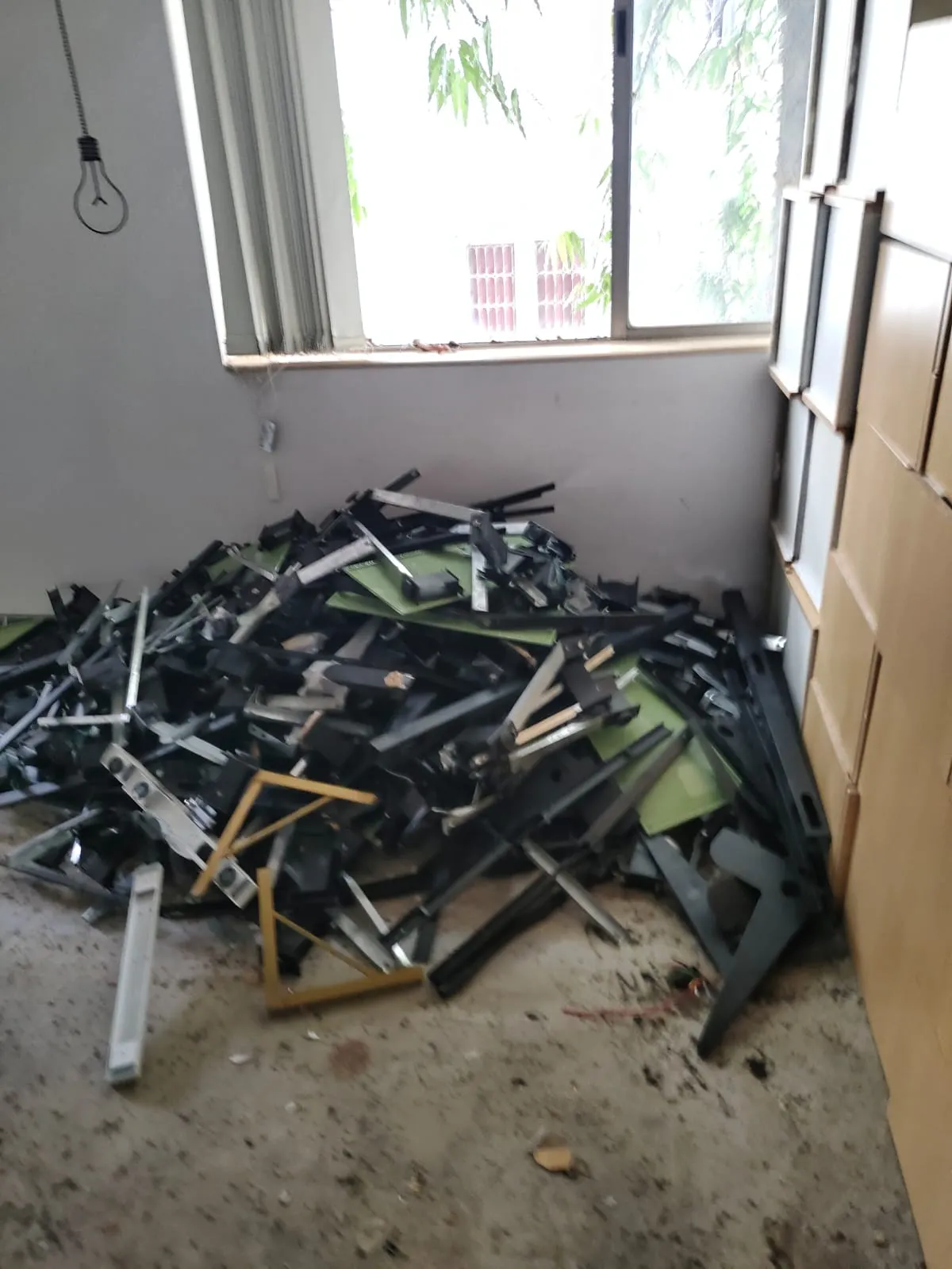 Pile of sorted aluminum and iron frame elements collected during office dismantling services in Marathahalli