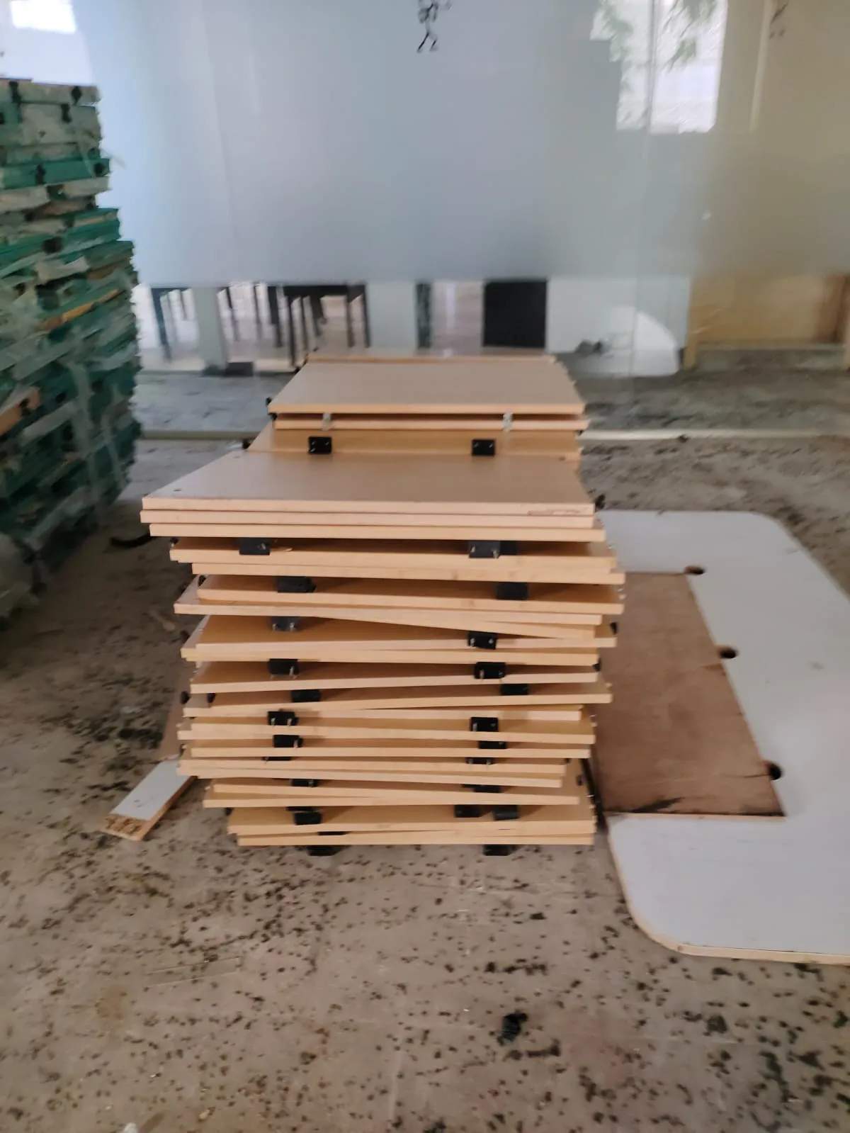 Wooden worktops and modular cubicle partitions flat-packed during a professional office furniture dismantling Marathahalli project.