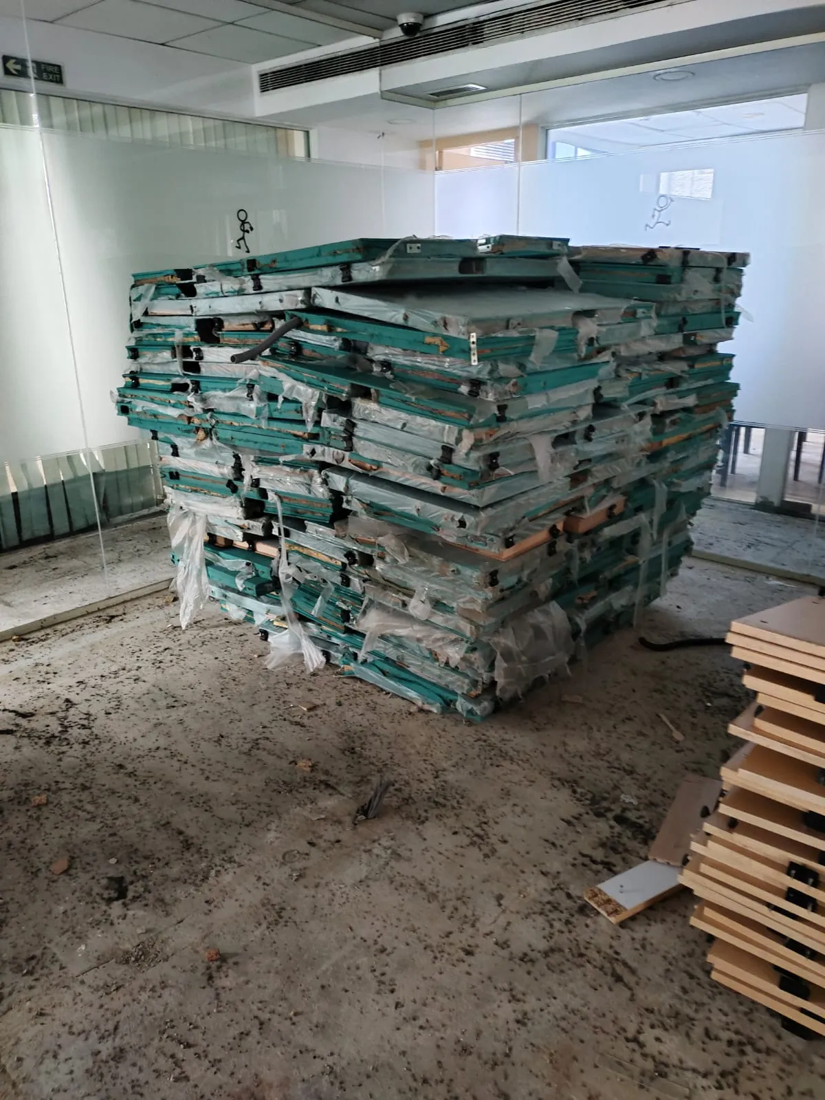 Protective wrapped stacks of fabric acoustics and partition divider boards optimized for office partition removal Marathahalli